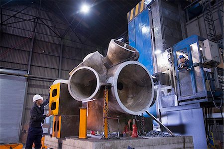 Worker using machinery in steel forge Stock Photo - Premium Royalty-Free, Code: 6122-07704349