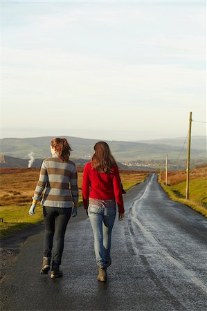 Women walking on rural road Stock Photo - Premium Royalty-Free, Code: 6122-07704395