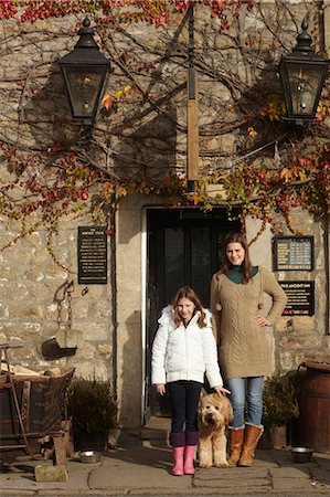 family portrait daughter dog - Family standing at historic building Stock Photo - Premium Royalty-Free, Code: 6122-07704414