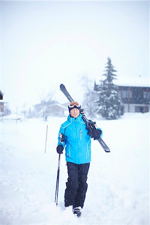 simsearch:6122-07706662,k - Man carrying skis and poles in snow Stock Photo - Premium Royalty-Free, Code: 6122-07704513