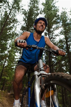 Man mountain biking in forest Stock Photo - Premium Royalty-Free, Code: 6122-07704994