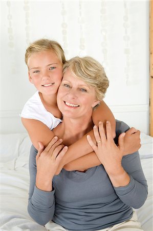 simsearch:6122-07705566,k - Girl hugging grandmother on bed Stock Photo - Premium Royalty-Free, Code: 6122-07704938