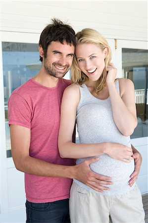 Man holding pregnant girlfriends belly Stock Photo - Premium Royalty-Free, Code: 6122-07704939