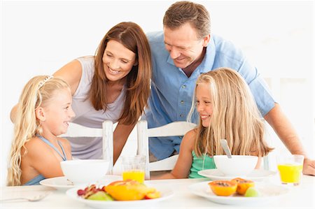 simsearch:6122-07703065,k - Family talking at breakfast table Stock Photo - Premium Royalty-Free, Code: 6122-07705043