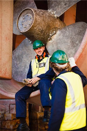 simsearch:6122-07705070,k - Workers talking in propeller on dry dock Stock Photo - Premium Royalty-Free, Code: 6122-07705071