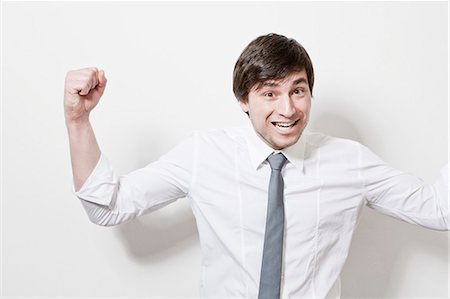 Businessman cheering in office Stock Photo - Premium Royalty-Free, Code: 6122-07705156