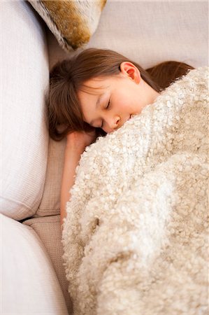 simsearch:6126-08635074,k - Girl sleeping under blanket on sofa Stock Photo - Premium Royalty-Free, Code: 6122-07705254