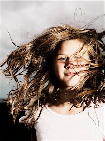 Girls hair blowing in wind outdoors Stock Photo - Premium Royalty-Free, Code: 6122-07705288