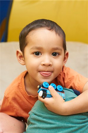 Boy playing with toy train Stock Photo - Premium Royalty-Free, Code: 6122-07705372