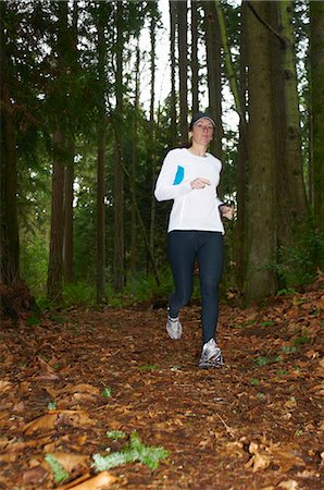simsearch:6122-07703835,k - Woman running in forest Stock Photo - Premium Royalty-Free, Code: 6122-07705386