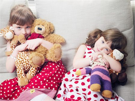polka dot - Girls holding stuffed animals on sofa Stock Photo - Premium Royalty-Free, Code: 6122-07705328