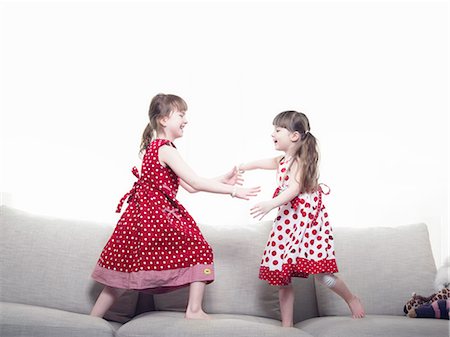 polka dot - Girls playing together on sofa Stock Photo - Premium Royalty-Free, Code: 6122-07705332