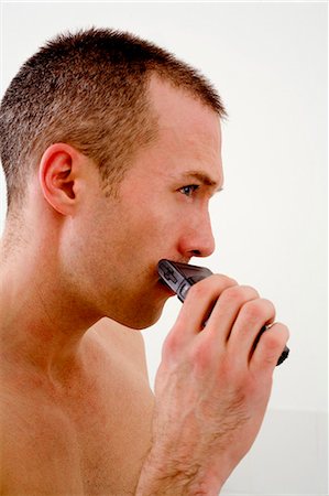 simsearch:693-06019176,k - Man shaving face in bathroom Stock Photo - Premium Royalty-Free, Code: 6122-07705425