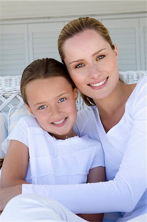 simsearch:6122-07705566,k - Mother and daughter relaxing on sofa Stock Photo - Premium Royalty-Free, Code: 6122-07705569