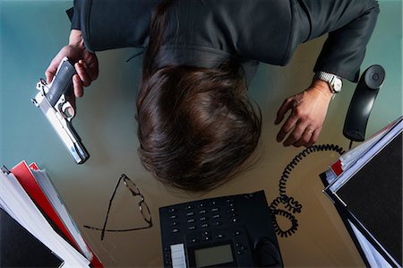 desk directly above - Businessman with gun face down on desk Stock Photo - Premium Royalty-Free, Code: 6122-07705653