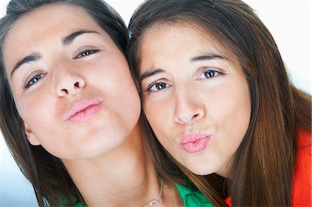 Women making kissy faces together Stock Photo - Premium Royalty-Free, Code: 6122-07705662