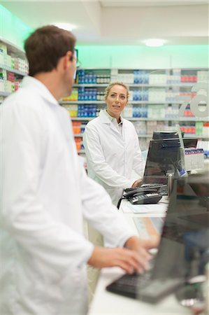 Pharmacists using computer at counter Stock Photo - Premium Royalty-Free, Code: 6122-07705767