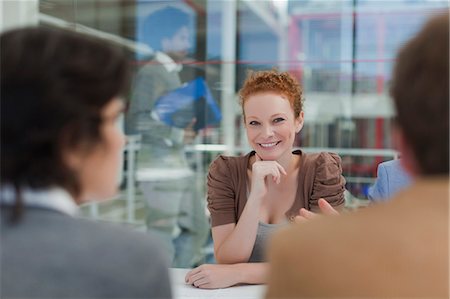 roundtable discussion - Businesswoman smiling in meeting Stock Photo - Premium Royalty-Free, Code: 6122-07705712