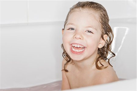 Smiling girl laughing in bath Stock Photo - Premium Royalty-Free, Code: 6122-07705819