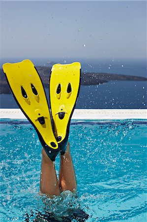 santorini island greece and people - Fins splashing in swimming pool Stock Photo - Premium Royalty-Free, Code: 6122-07705963