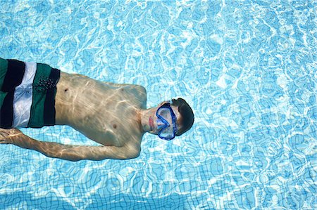 person submerged underwater - Teenage boy wearing goggles in pool Stock Photo - Premium Royalty-Free, Code: 6122-07705964