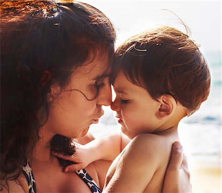 sad boy for mom - Mother and toddler kissing on beach Stock Photo - Premium Royalty-Free, Code: 6122-07705970