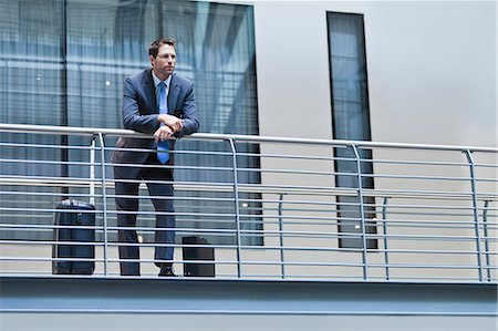 simsearch:6113-06497878,k - Businessman standing on balcony Stock Photo - Premium Royalty-Free, Code: 6122-07706171