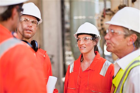 Workers walking at oil refinery Stock Photo - Premium Royalty-Free, Code: 6122-07706247