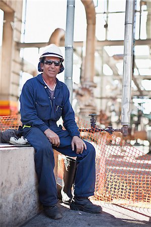 Worker sitting at oil refinery Stock Photo - Premium Royalty-Free, Code: 6122-07706248