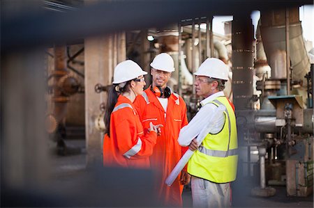 Workers talking at oil refinery Stock Photo - Premium Royalty-Free, Code: 6122-07706251