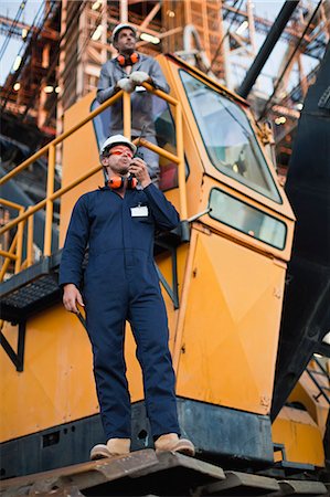 engineer efficiency - Worker using walkie talkie on site Stock Photo - Premium Royalty-Free, Code: 6122-07706264