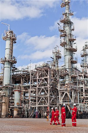 Workers talking at oil refinery Stock Photo - Premium Royalty-Free, Code: 6122-07706270