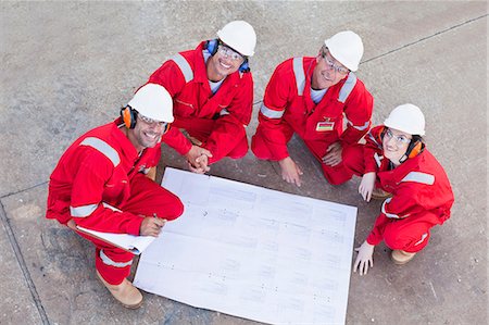 refinery confidence - Workers with blueprints at oil refinery Stock Photo - Premium Royalty-Free, Code: 6122-07706277