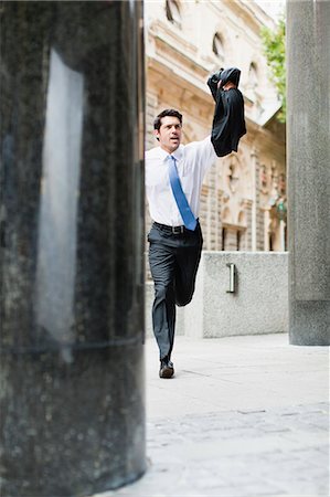 running business front - Businessman running on city street Stock Photo - Premium Royalty-Free, Code: 6122-07706220