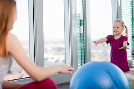 Girls playing with exercise ball in gym Stock Photo - Premium Royalty-Free, Code: 6122-07706447