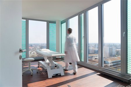 doctor walking - Blurred view of doctor in office Stock Photo - Premium Royalty-Free, Code: 6122-07706479