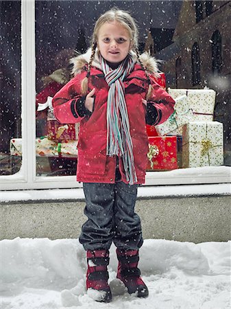 shop night windows - Smiling girl standing in snow Stock Photo - Premium Royalty-Free, Code: 6122-07706499