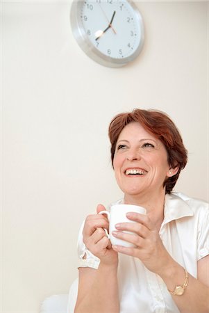 Smiling woman having cup of coffee Stock Photo - Premium Royalty-Free, Code: 6122-07706418