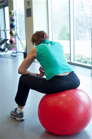 simsearch:6122-07703692,k - Woman using exercise ball in gym Foto de stock - Royalty Free Premium, Número: 6122-07706633