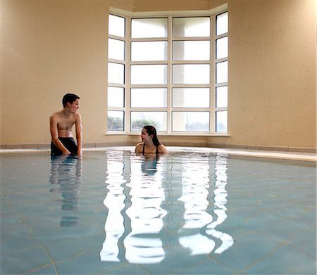 friends swimming - Teenagers talking in swimming pool Stock Photo - Premium Royalty-Free, Code: 6122-07706704