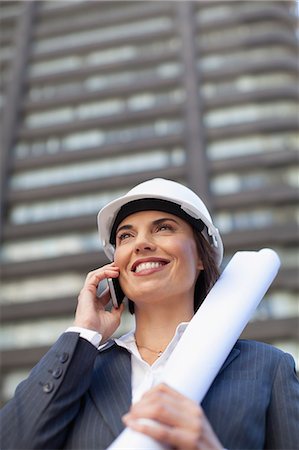 Businesswoman with blueprints outdoors Stock Photo - Premium Royalty-Free, Code: 6122-07706734