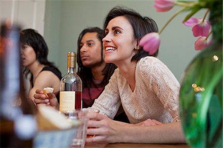 dinner party friends indoors young adults - Woman talking at dinner table Stock Photo - Premium Royalty-Free, Code: 6122-07706834