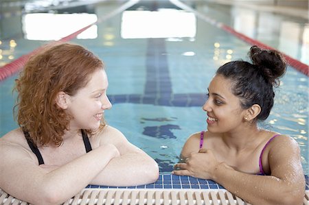 swimming pool leaning on edge - Women talking in indoor pool Stock Photo - Premium Royalty-Free, Code: 6122-07706991