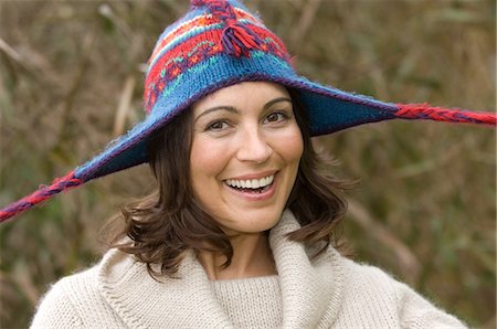 pull funny - Smiling woman wearing knitted hat Stock Photo - Premium Royalty-Free, Code: 6122-07707076