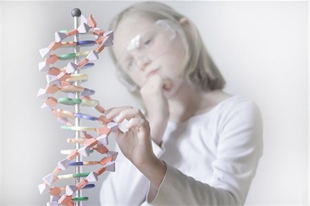 Girl examining molecular model Stock Photo - Premium Royalty-Free, Code: 6122-07707099