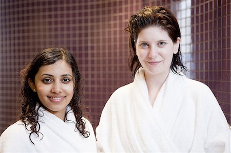 Women in bathrobes smiling in shower Stock Photo - Premium Royalty-Free, Code: 6122-07707003