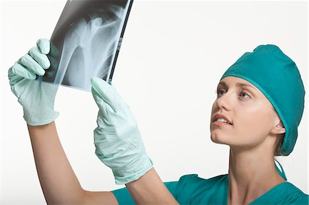 rubber gloves lady surgeon - Surgeon examining x-rays Stock Photo - Premium Royalty-Free, Code: 6122-07707369