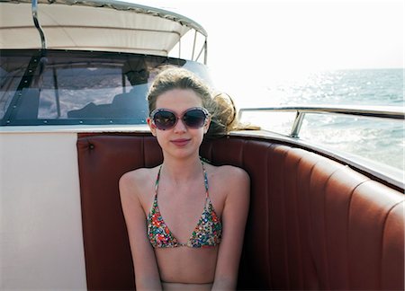 swimming suits for 12 years old girls - Smiling girl wearing sunglasses on boat Stock Photo - Premium Royalty-Free, Code: 6122-07707457