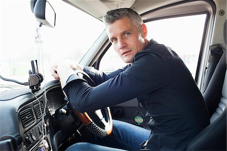 driver (car, male) - Taxi driver sitting at steering wheel Stock Photo - Premium Royalty-Free, Code: 6122-07707427