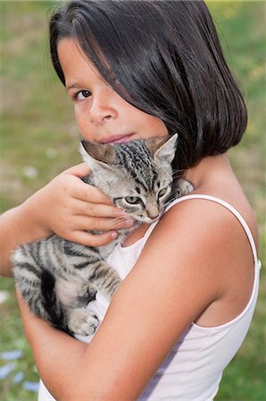 Girl holding pet cat, portrait Stock Photo - Premium Royalty-Free, Code: 6122-08212425